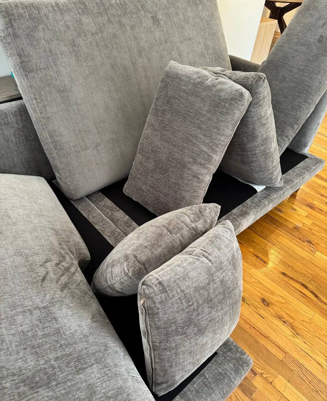Couch cushions propped up mid-clean during a Pine Cleaning visit